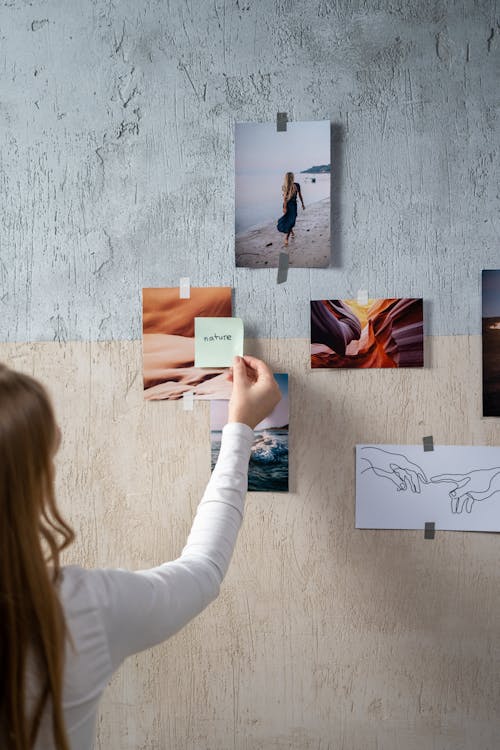 Back View of a Woman Putting a Sticky Note on a Moodboard