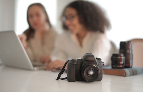 Professional photo camera on table in bright room