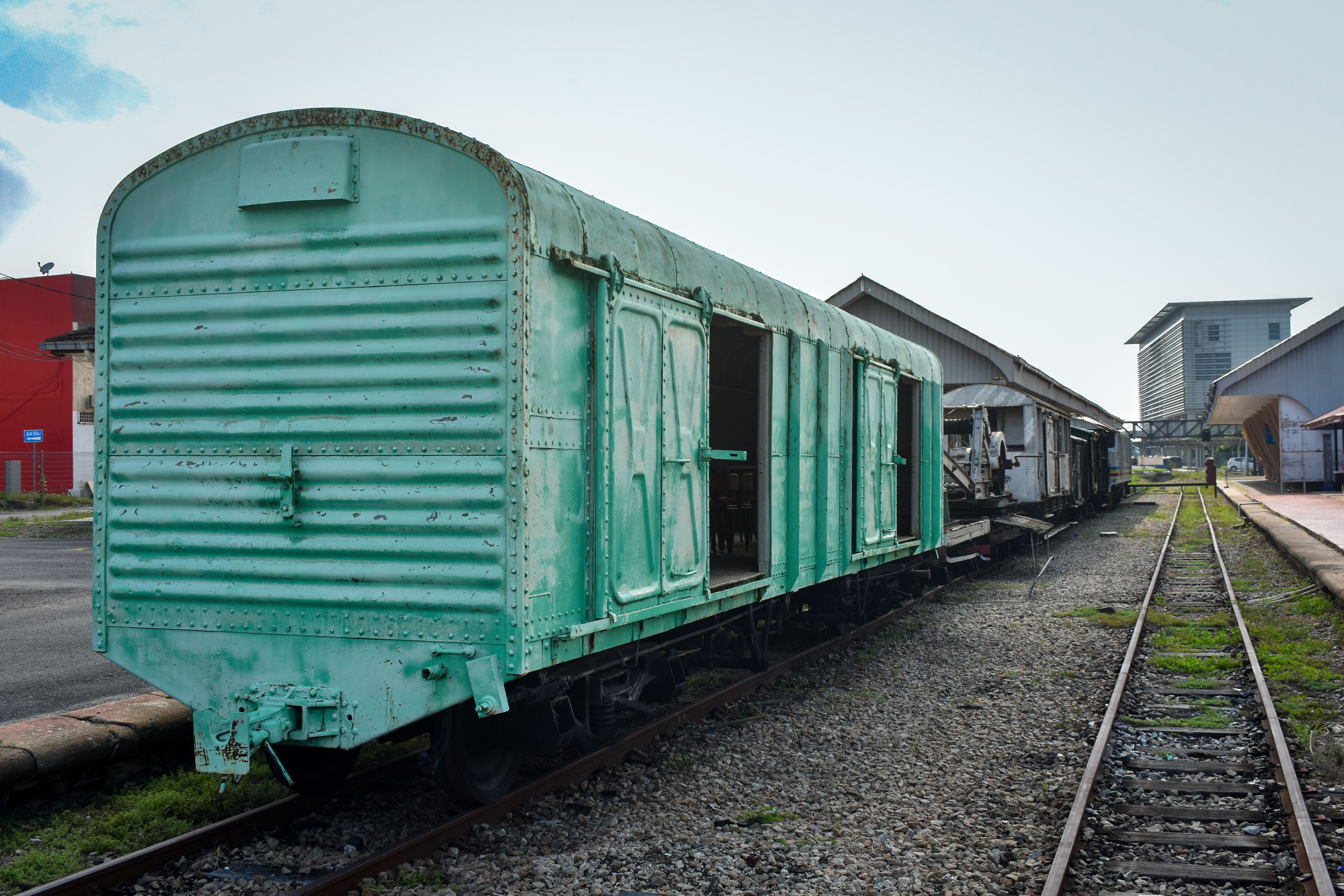 Rustic green train carriage at Gemas Station, Negeri Sembilan, Malaysia.