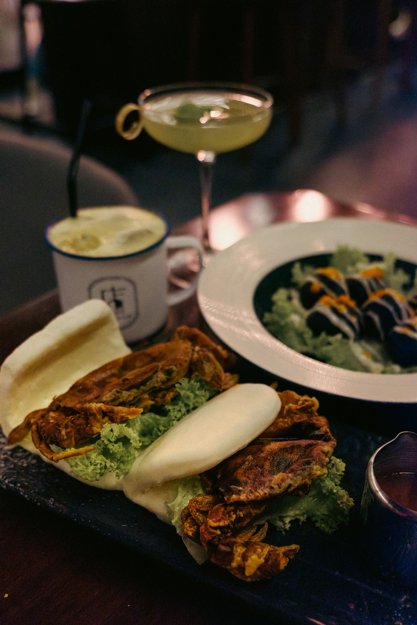 Soft-shell crab bao buns served on a restaurant table