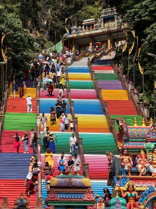 Free Colorful staircase at Batu Caves filled with diverse visitors in Kuala Lumpur, Malaysia. Stock Photo