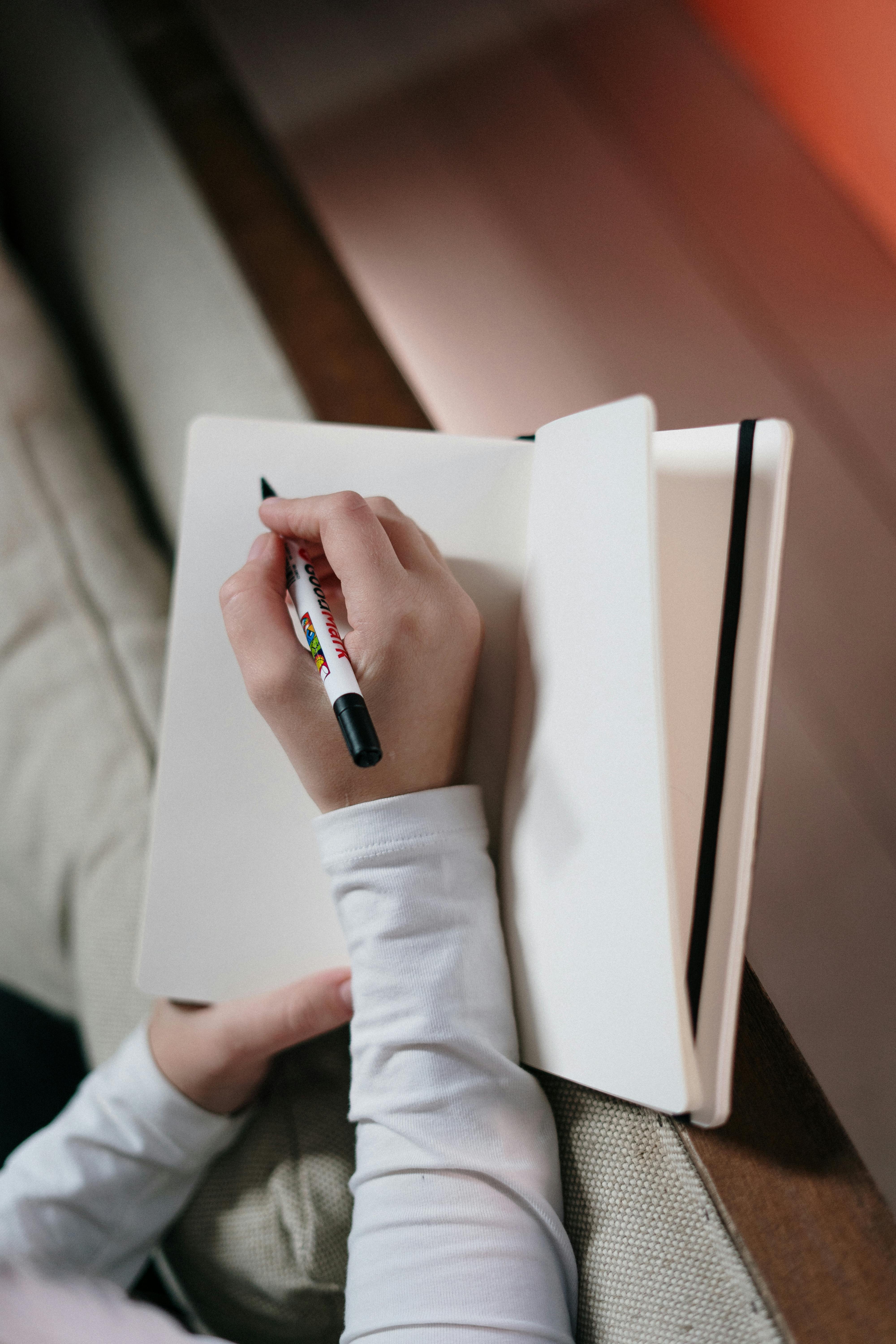 Green Spring Bind Book Beside 2 Blue Pens · Free Stock Photo