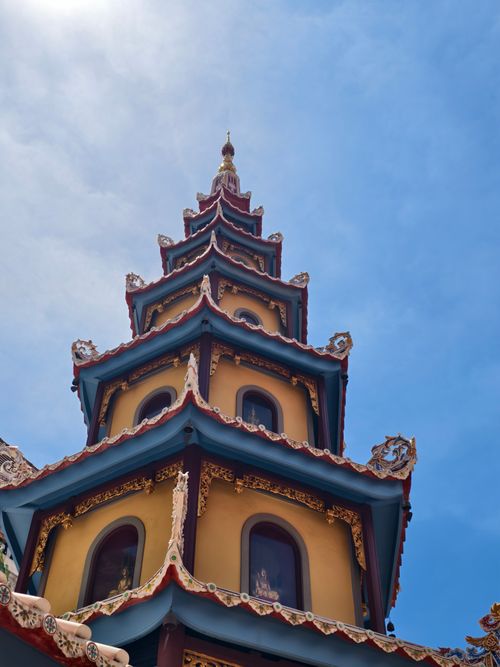 Free A beautifully crafted pagoda tower reaches towards a clear blue sky in Bangkok, Thailand. Stock Photo