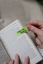 Hands holding a book with a green sticky note labeled 'idea for pexels'.