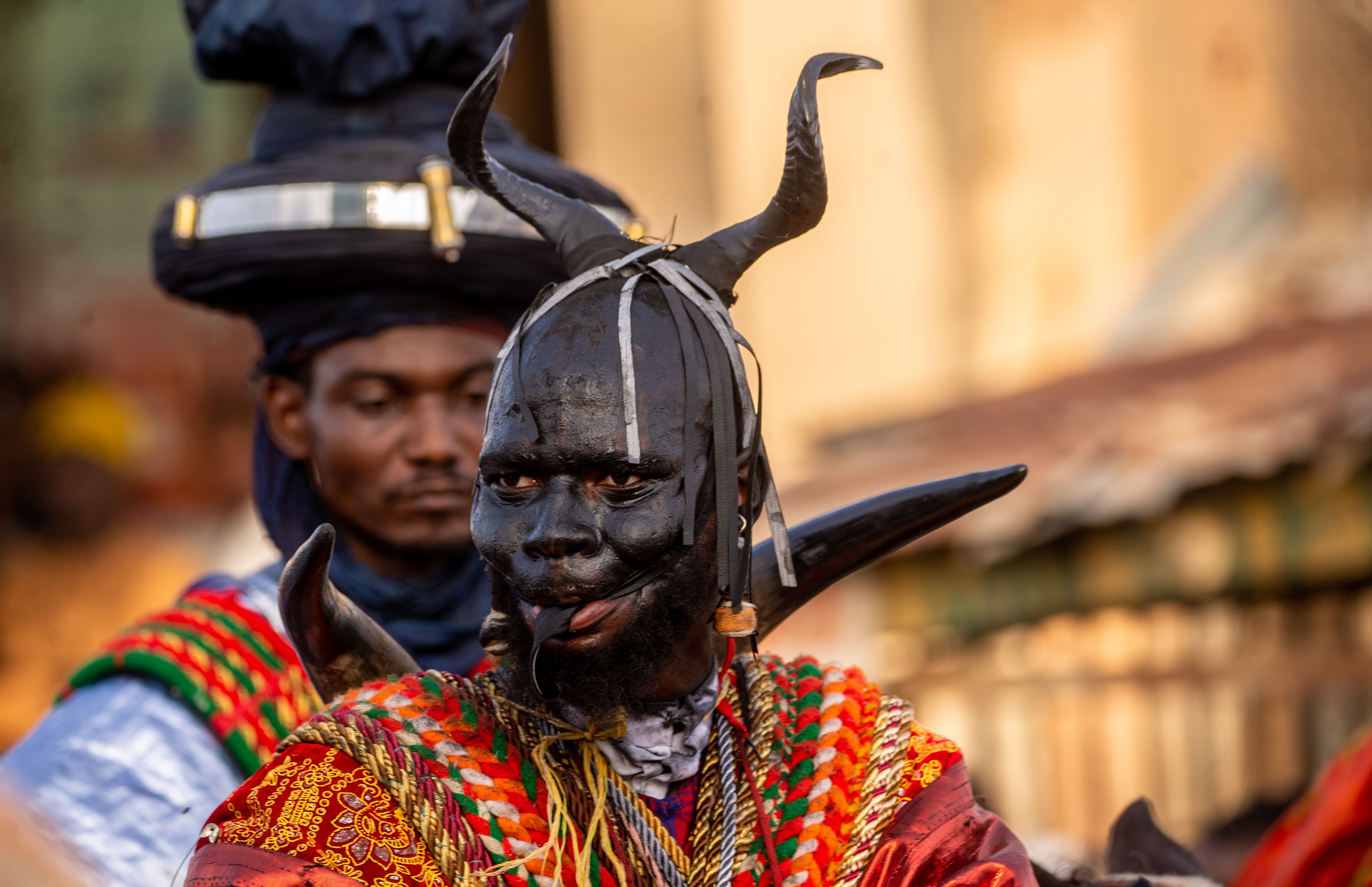 Vibrant African traditional festival featuring cultural costumes and masks in Katsina, Nigeria.