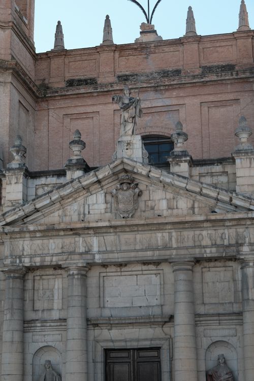 Free Detailed view of a historic architectural facade featuring stone carvings and statues in Spain. Stock Photo
