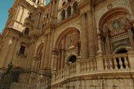 Detailed view of the ornate facade of Malaga Cathedral, highlighting its Renaissance architecture.