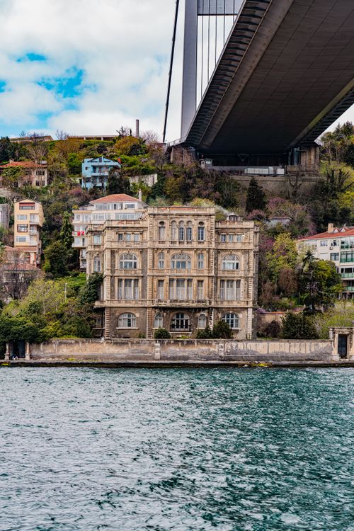 Free Historic waterfront mansion under the Bosphorus Bridge in Istanbul, Turkey. Stock Photo