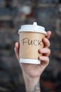 Close-Up Shot of a Person Holding a Disposable Cup