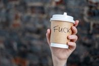 Close-Up Shot of a Person Holding a Disposable Cup
