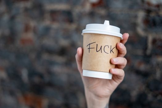 Close-Up Shot of a Person Holding a Disposable Cup