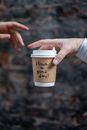 Person Holding a Disposable Cup