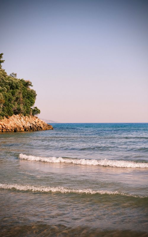 Free Tranquil coastal scene featuring clear blue water and a rocky shoreline in Aydın, Türkiye. Stock Photo