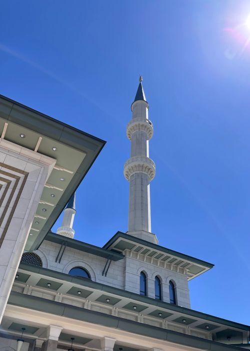 Free A captivating view of a mosque's minaret under a bright blue sky in Ankara, showcasing architectural elegance. Stock Photo