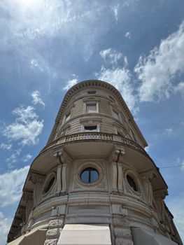 Low-angle view of a historic building in Mantova, Italy with a clear blue sky.