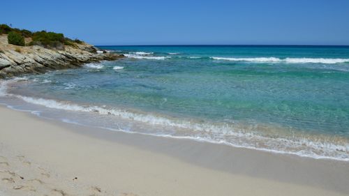 Free Beautiful white sand beach in Corse, France with azure water under a clear blue sky. Stock Photo