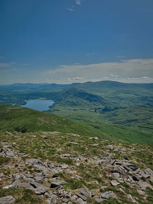 Free Breathtaking view of lush Irish highlands and lake under a clear summer sky. Stock Photo