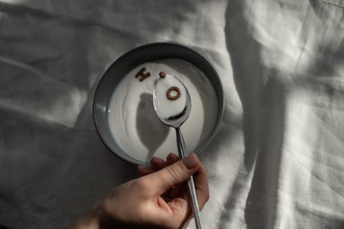 Person Holding Stainless Steel Spoon