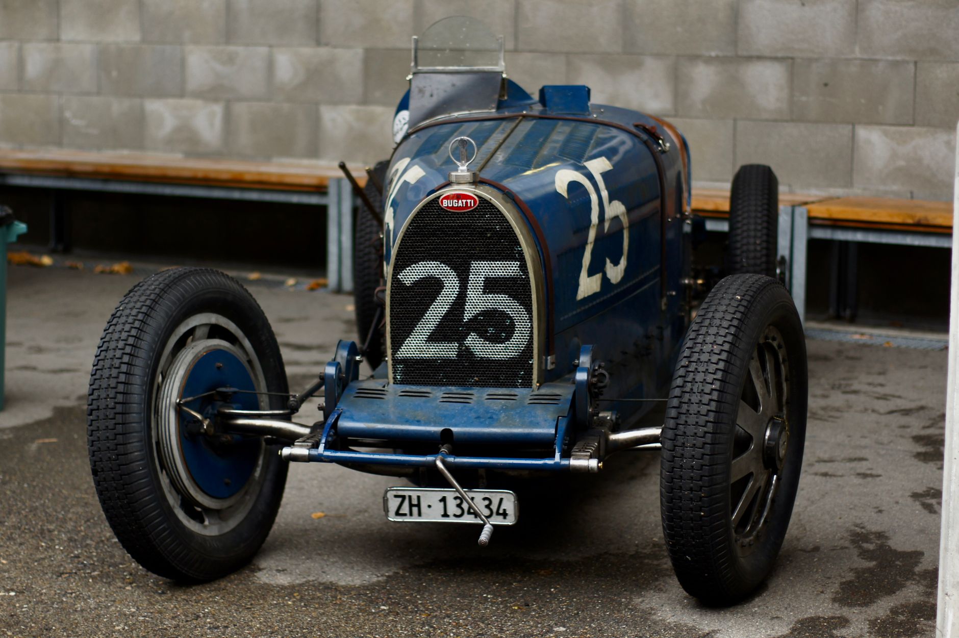 Front view of a vintage Bugatti race car with license plate ZH-133434 in Switzerland.