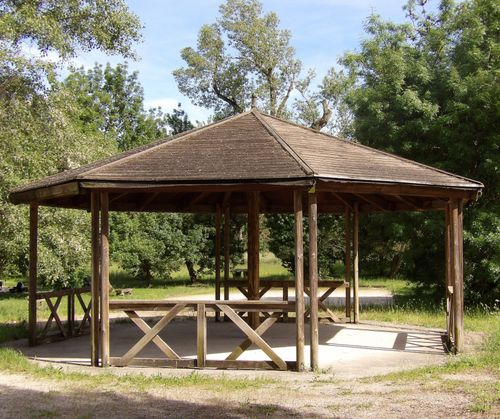 Free Wooden gazebo surrounded by greenery in a Saint-Péray park, perfect for picnics. Stock Photo