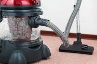 Black and Red Canister Vacuum Cleaner on Floor