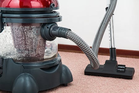 Free Black and Red Canister Vacuum Cleaner on Floor Stock Photo