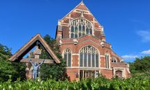 Beautiful view of All Saints Church in East Finchley, London, with blue skies.