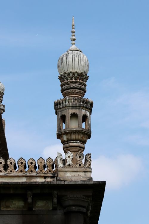 Free Close-up view of an intricately designed minaret against a clear blue sky, showcasing detailed architecture. Stock Photo