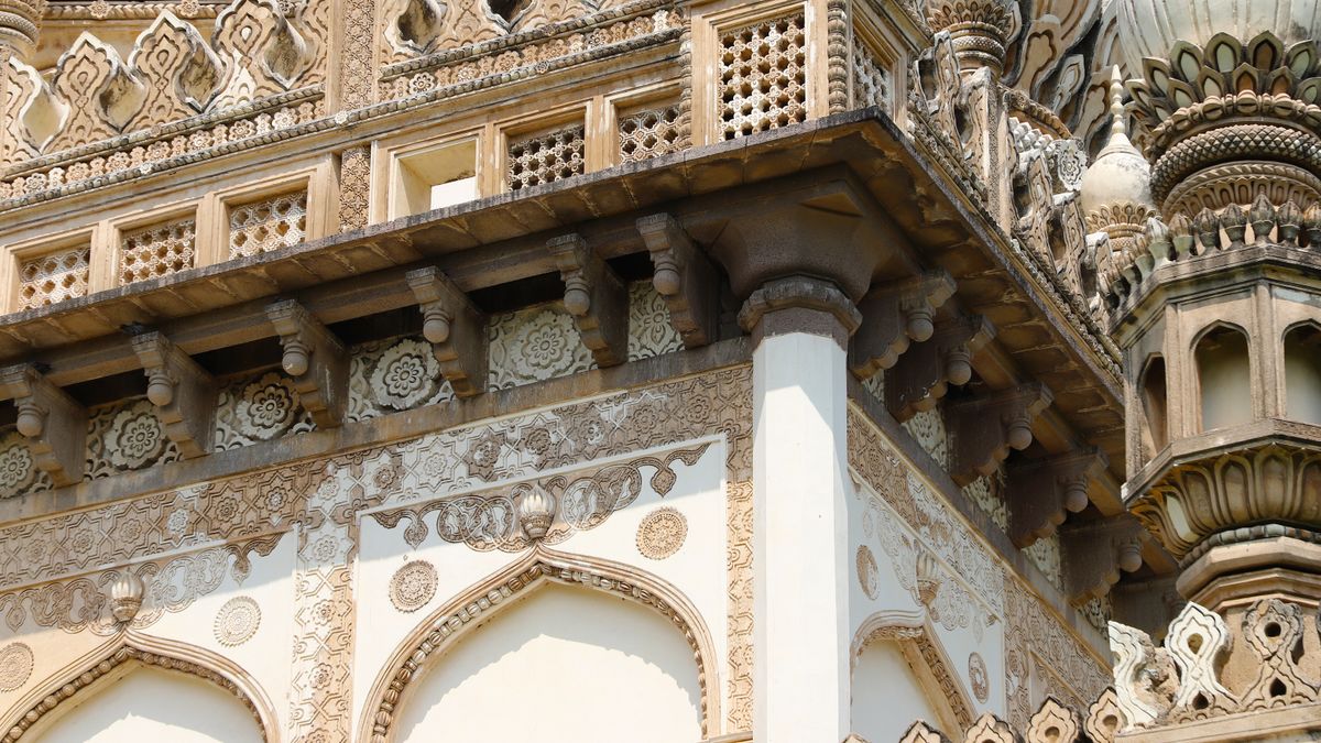 Close-up of ornate architectural details on a historic building facade in Hyderabad, India.