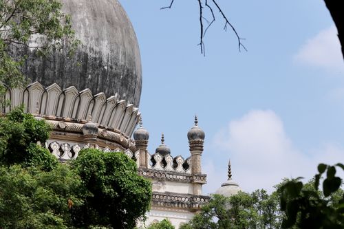 Free Beautiful architectural dome surrounded by green trees under a bright blue sky. Stock Photo