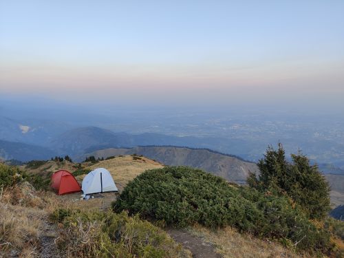 Free Beautiful view from a mountain campsite with tents overlooking Almaty city at dusk. Stock Photo