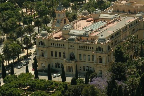 Free Aerial view of the historic Ayuntamiento de Málaga surrounded by lush greenery in Spain. Stock Photo