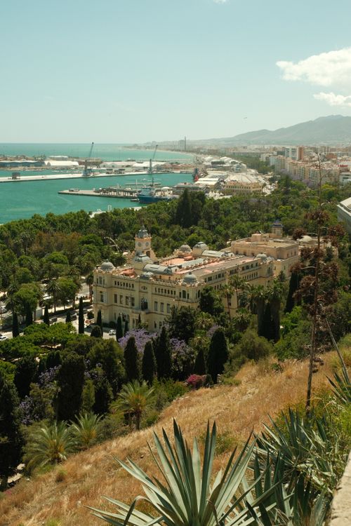 Free A picturesque view of El Ayuntamiento de Málaga against the cityscape and harbor, captured in Spain. Stock Photo