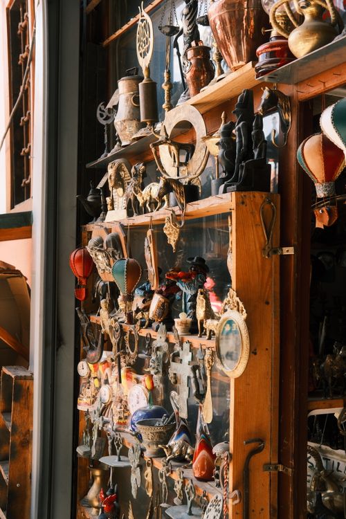 Free A sunlit display of vintage items and trinkets showcasing eclectic artistry in an antique shop. Stock Photo
