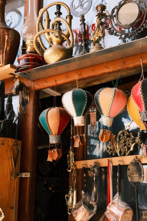 Free Vibrant hot air balloon decorations hanging in a vintage-style antique shop display window. Stock Photo