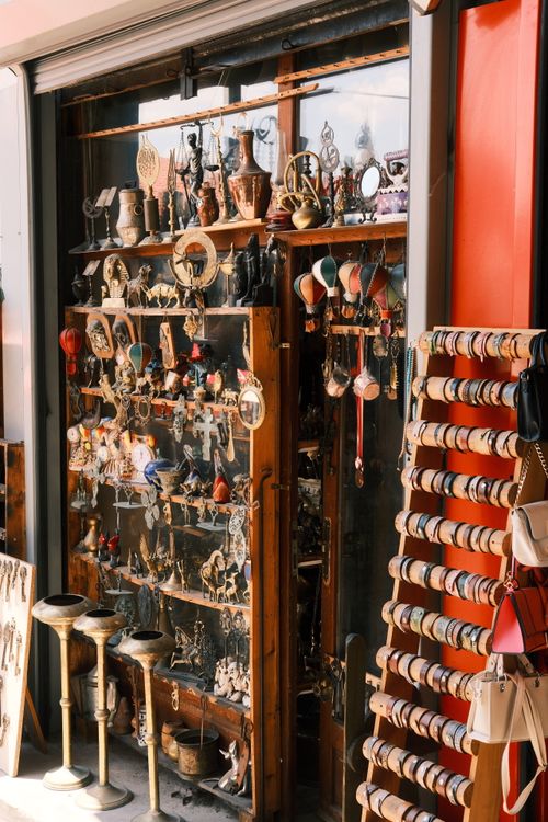 Free Charming antique shop window filled with vintage artifacts and handcrafted accessories. Stock Photo