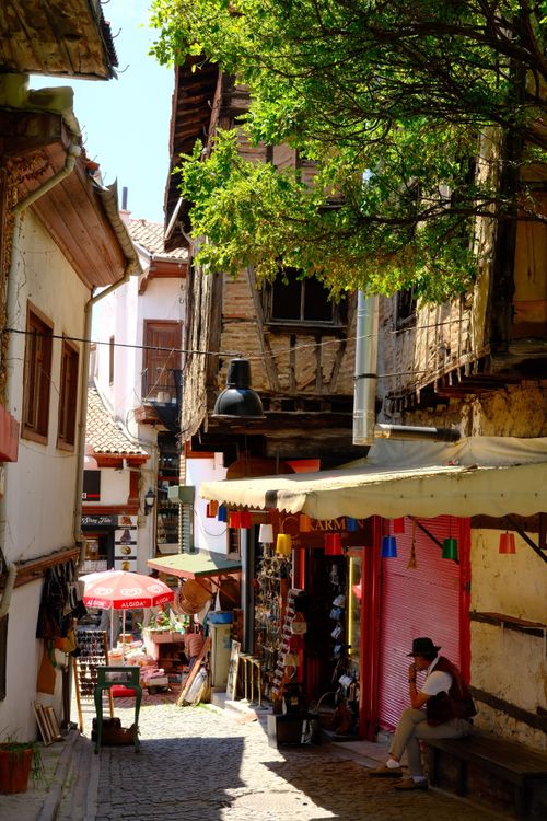 Free Charming cobblestone alley with shops on a sunny day, perfect for exploring. Stock Photo