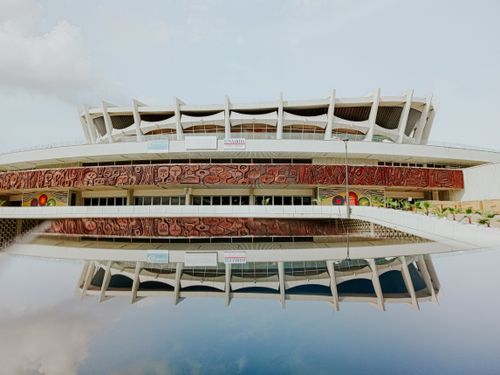 Free The iconic National Theatre in Lagos, Nigeria, beautifully reflected in still water. Stock Photo