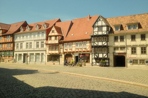 Free Traditional half-timbered buildings in Quedlinburg, Germany, with a cobblestone street. Stock Photo