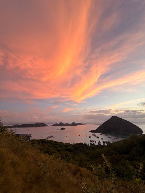 Free Dramatic sunset over Komodo Island with vibrant skies and serene waters, Bali, Indonesia. Stock Photo