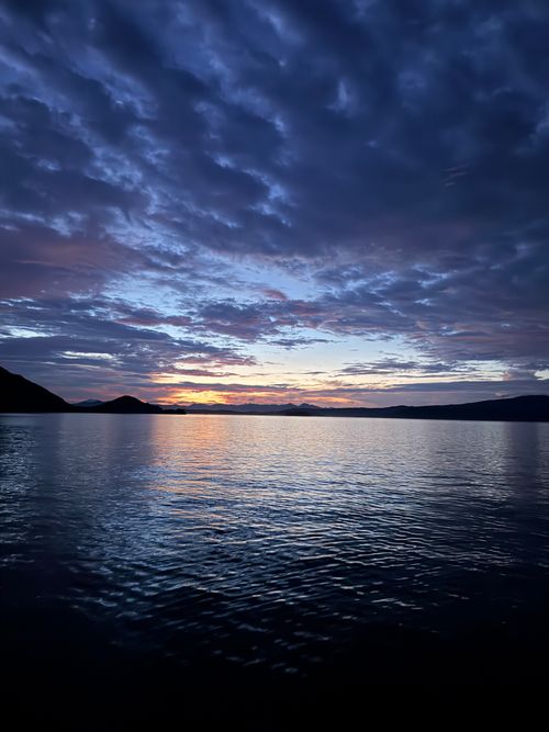 Free Breathtaking sunset over calm waters in Bali, Indonesia. Perfect tranquility captured in rich colors. Stock Photo