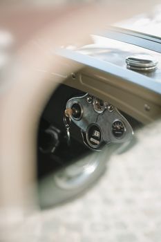 Vintage car dashboard with retro instruments and key, shot in Kosovo.