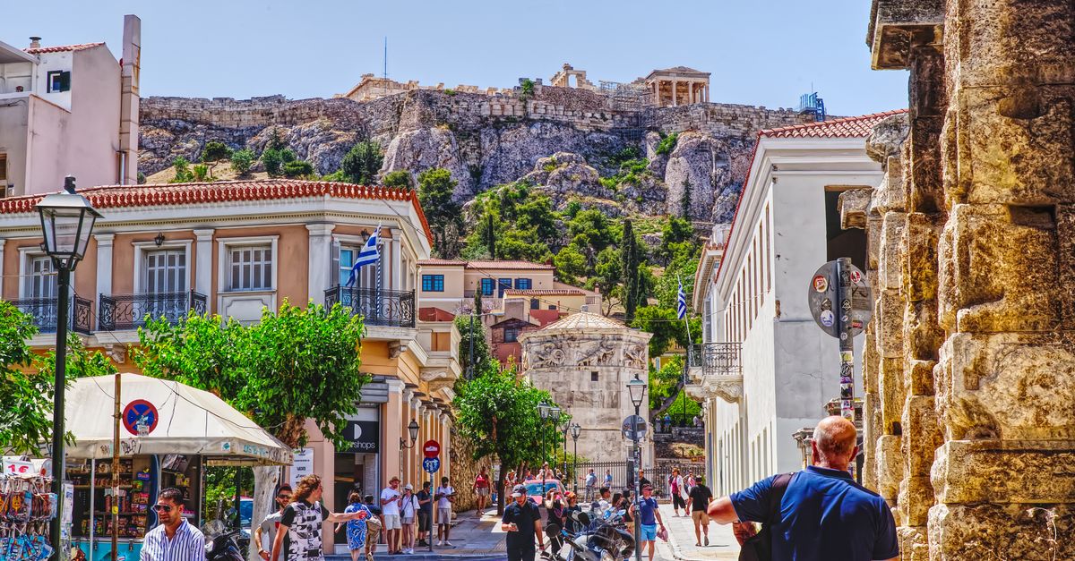 A street in central Athens with the Acropolis on the hill above it.