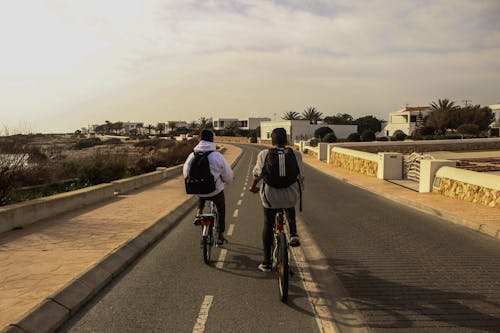 People Riding Bicycles On The Road