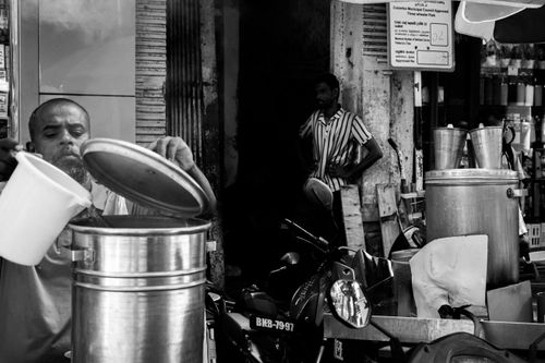 Free Black and white image of a street vendor preparing food in Colombo, Sri Lanka. Stock Photo