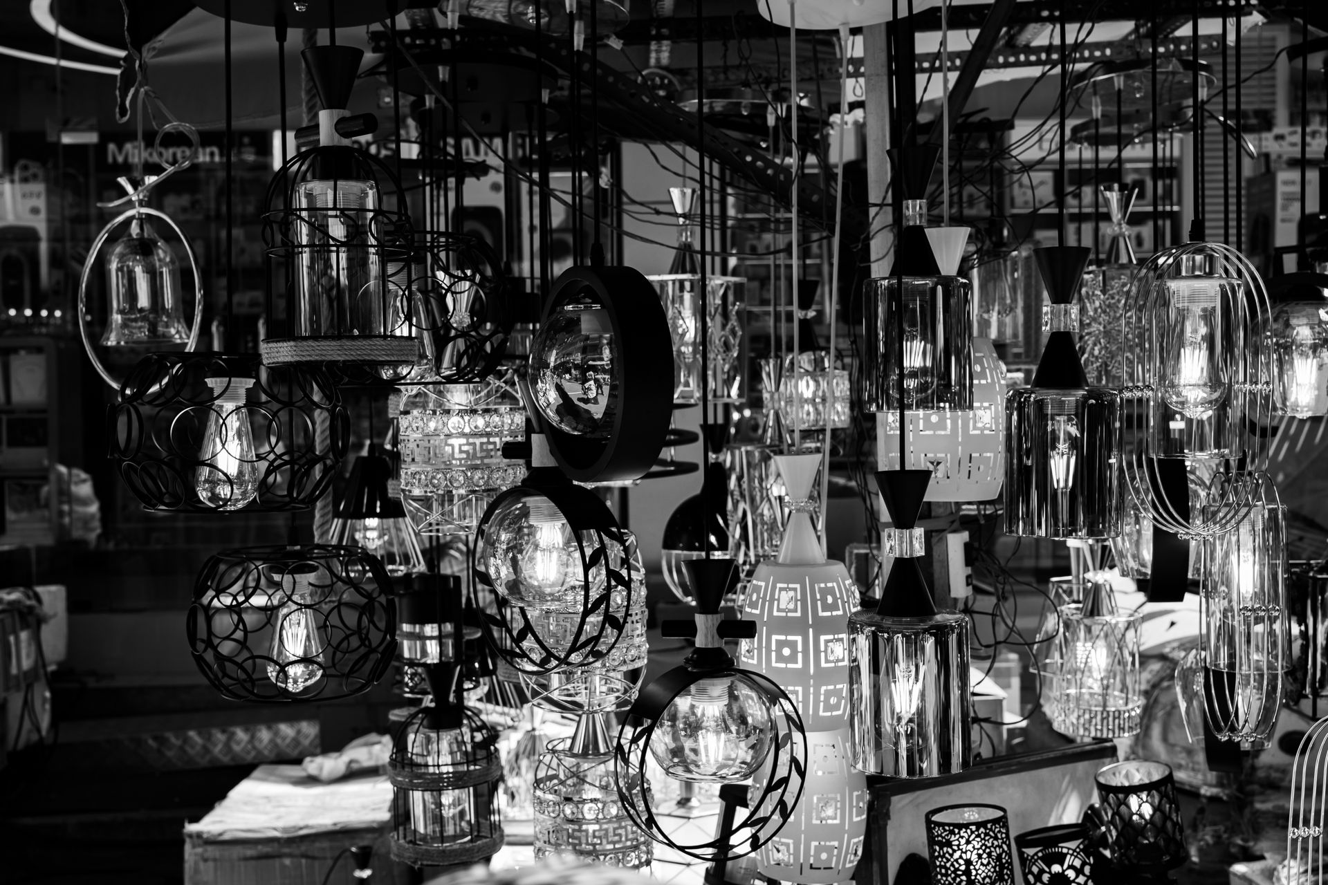 Various hanging lighting fixtures displayed closely together in a showroom