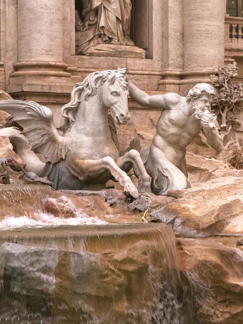 Free Elegant stone sculpture of Neptune with a horse at the iconic Trevi Fountain in Rome. Stock Photo