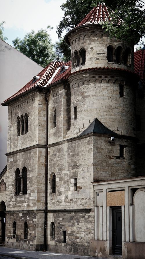 Free Stone building with a medieval design and red tiled roof surrounded by city surroundings. Stock Photo