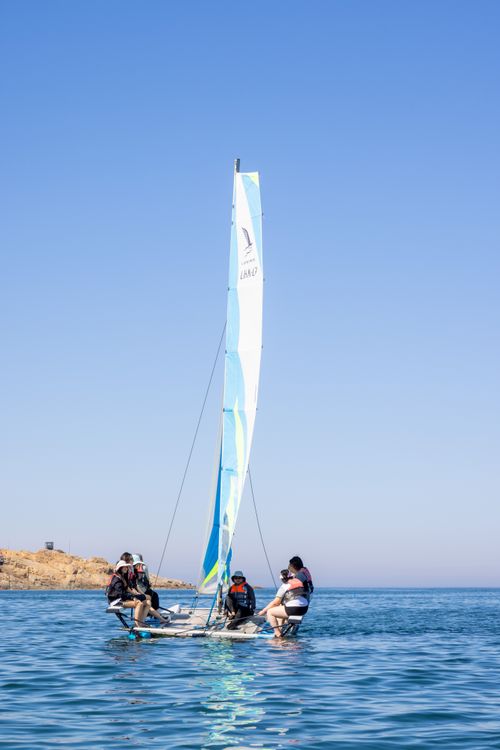 Free A group enjoys sailing on a bright sunny day with clear blue waters and sky. Stock Photo