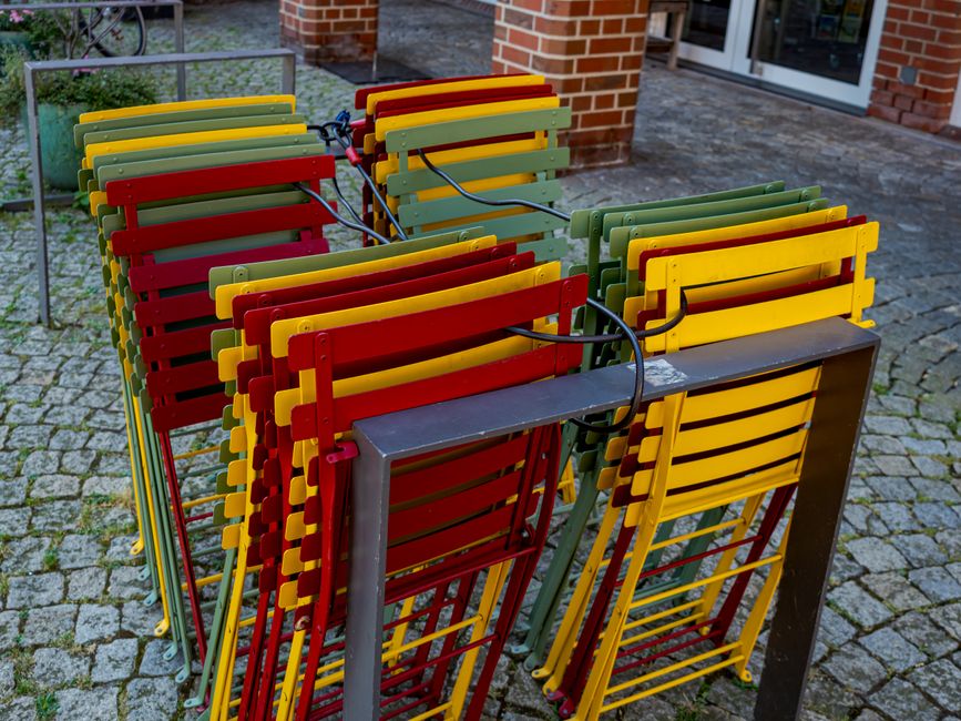 stack colorful art prints studio table